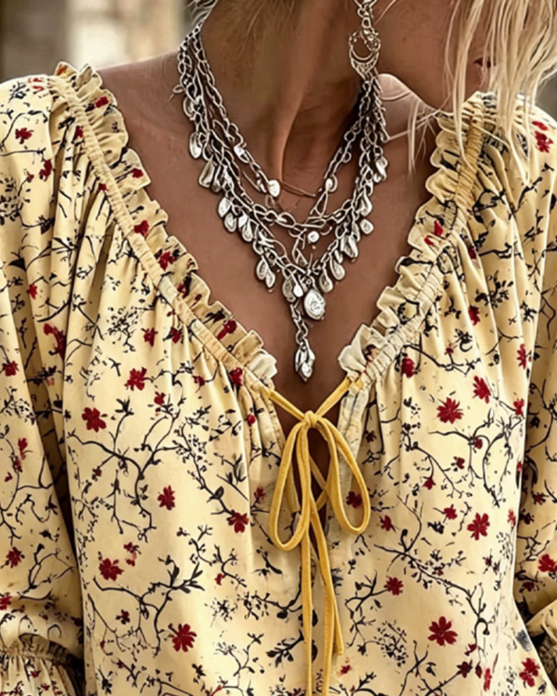 Yellow floral print 3/4 sleeve blouse with tie detail, back view