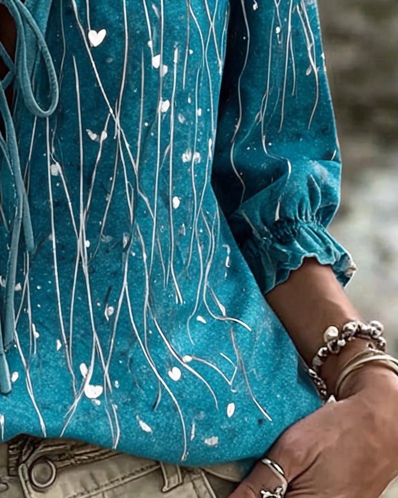 Blue 3/4 sleeve heart print blouse with tie detail, back view