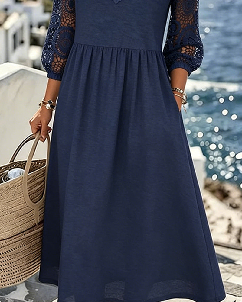 Navy blue lace patchwork dress detail, close-up view
