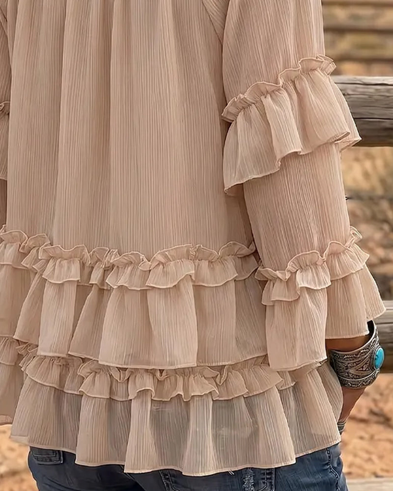 Beige flare ruffle blouse detail, close-up view