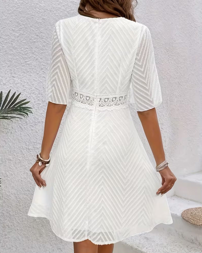 White cutout lace patchwork mini dress, three-quarter view