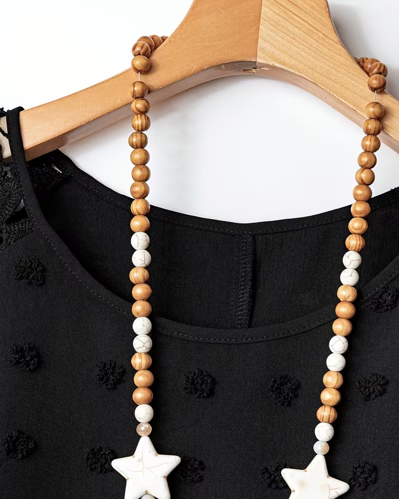 Black lace patchwork mini dress detail, close-up view
